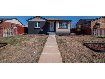 Charming single-story home with a walkway, neutral color palette, manicured front yard, and a welcoming entrance at 3360 Magnolia St, Denver, CO 80207