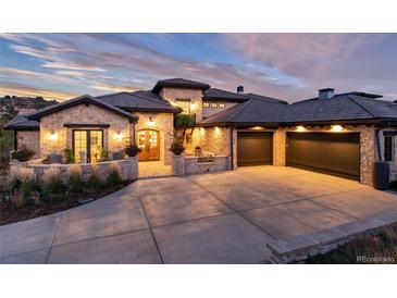 Stunning stone house with a three-car garage and well-manicured landscaping at 7952 Dante Dr, Littleton, CO 80125