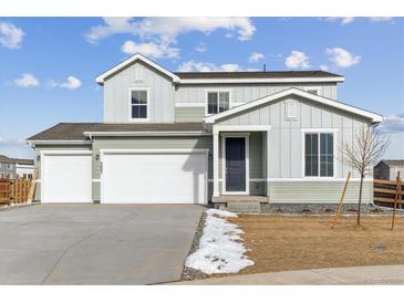 Two-story house with a white and green exterior, two-car garage, and landscaping at 5805 Farmstead Pl, Mead, CO 80504