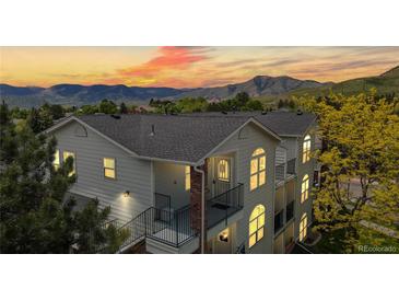 Charming multi-level home with mountain views, balconies, and arched windows at sunset at 1670 S Deframe St # C2, Lakewood, CO 80228
