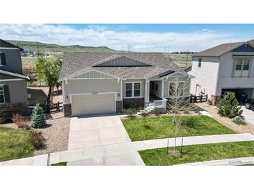 Charming single Gathering home with a well-manicured lawn and an attached two car garage at 11829 Deorio St, Parker, CO 80134