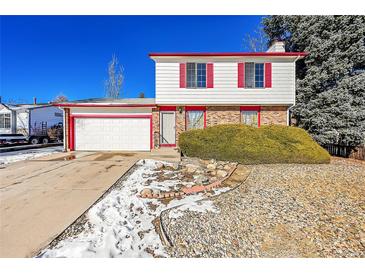 Two-story house with a white exterior, red accents, and a two-car garage at 17009 E Loyola Pl, Aurora, CO 80013