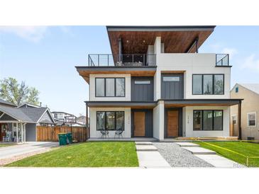 Stunning modern exterior with a second-story balcony and manicured front lawn at 2926 S Cherokee St, Englewood, CO 80110