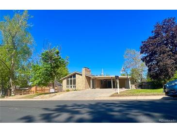 Charming single-story home with brick facade, covered parking, and a well-manicured front yard at 414 S Nelson S St, Lakewood, CO 80226