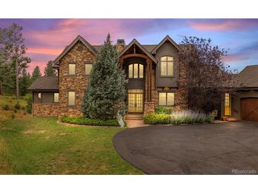 Stunning two-story home with stone accents and a landscaped yard at 1138 County Road 65, Evergreen, CO 80439