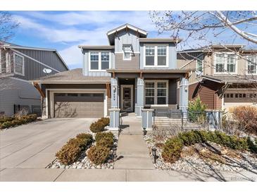 Charming two-story home featuring a well-manicured front yard and attached garage, showcasing great curb appeal at 9099 Prairie Sky Ln, Lone Tree, CO 80124