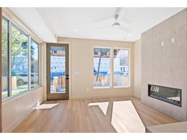 Bright living room featuring a fireplace and hardwood floors at 2325 S High St, Denver, CO 80210