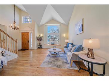 Bright living room with hardwood floors, vaulted ceilings and large window at 13471 Cascade St, Broomfield, CO 80020