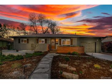 Charming home with landscaped front yard and stone walkway, set against a vibrant sunset sky at 4655 Ludlow St, Boulder, CO 80305