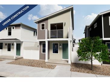 Charming two-story home with a balcony, neutral siding, and modern design elements at 10337 Vaughn Ave, Commerce City, CO 80022