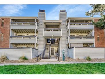 Three story condo building with multiple balconies and well maintained green space at 14226 E 1St Dr # B10, Aurora, CO 80011
