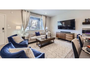 Inviting living room featuring plush seating, modern decor, and a cozy ambiance at 21613 E 59Th Pl, Aurora, CO 80019