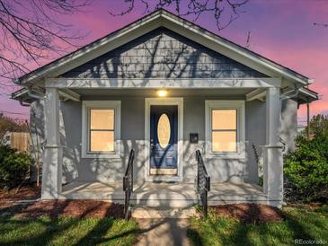 Charming home featuring a covered porch with classic columns and a decorative front door at 3855 N Cook St, Denver, CO 80205