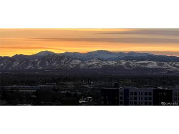 Breathtaking mountain view at sunrise with orange sky and snow-capped peaks, offering a serene backdrop at 300 W 11Th Ave # 10D, Denver, CO 80204