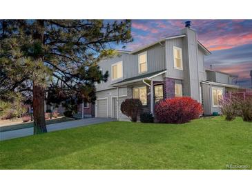 Charming home featuring a well-manicured lawn, mature tree, and attached two car garage at 1745 S Kline Way, Lakewood, CO 80232