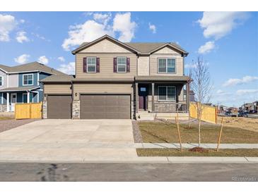 Charming two-story home with a covered front porch, three car garage, and neutral paint at 4107 Marble Dr, Mead, CO 80504