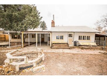 View of a house with a fire pit and patio in the backyard at 4263 S Elati St, Englewood, CO 80110