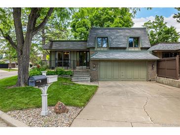 Charming two-story home with attached two car garage and manicured lawn at 7238 W Cedar Cir, Lakewood, CO 80226