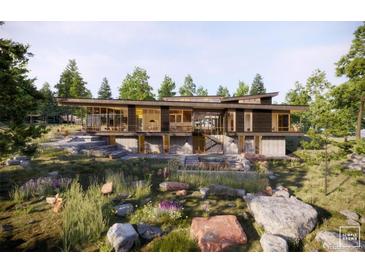 Stunning modern home with clean lines, large windows, and beautiful landscaping for a luxurious living experience at 53 Canyon Pines Dr, Golden, CO 80403