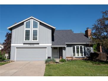 Charming two-story home featuring a gray exterior, attached garage, and well-manicured front lawn at 7600 S Ulster Ct, Centennial, CO 80112