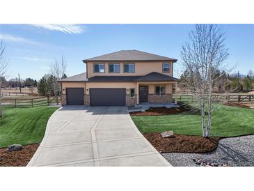 Inviting two-story home with an attached three-car garage and a long driveway at 12701 Strawberry Cir, Longmont, CO 80503