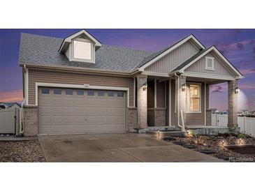 Inviting two-story home boasts a well-manicured lawn and an attached two-car garage at 5521 Ensenada St, Denver, CO 80249