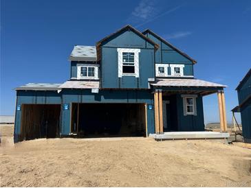 Two-story home exterior showing an attached two-car garage and a covered entryway in mid-construction at 39715 Gibson St, Elizabeth, CO 80107