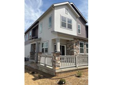 Beautiful two-story home with stone accents, neutral siding, and a charming front porch at 1988 S Haleyville Way, Aurora, CO 80018