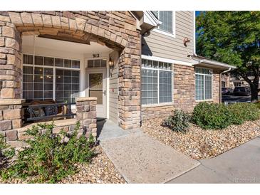 Charming front entrance featuring a stone archway and a cozy seating area at 12711 Colorado Blvd # 912, Thornton, CO 80241