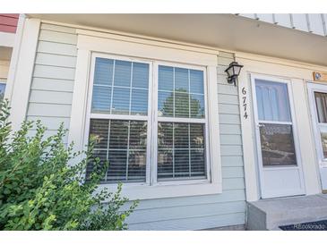 Charming townhome with updated windows, complemented by lush greenery for a welcoming curb appeal at 6774 S Independence St, Littleton, CO 80128