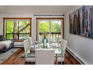 Bright dining area with glass table, seating for six, and views to the outside at 827 Maxwell Ave # H, Boulder, CO 80304