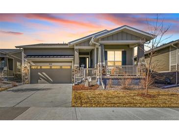 Charming single-Gathering home featuring stone accents, a covered porch, and a well-maintained front yard at 8501 S Rome Way, Aurora, CO 80016