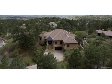 Stunning luxury home with a tile roof, landscaped grounds and a two-car garage at 214 Equinox Dr, Castle Rock, CO 80108