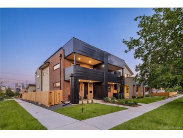 Modern two-story townhome features brick and dark metal exterior, landscaped yard, and inviting curb appeal at 2090 Eliot St, Denver, CO 80211