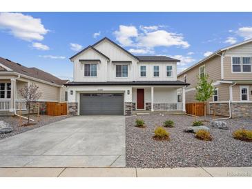 Charming two-story home features a well-maintained yard and a two-car garage at 25303 E Warren Pl, Aurora, CO 80018