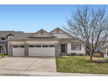 Charming single-Gathering home with a three-car garage, manicured lawn, and inviting curb appeal at 15870 Duckweed Ct, Parker, CO 80134