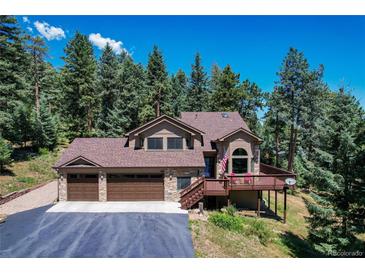Charming two-story home featuring a three-car garage, stone accents and a welcoming porch at 8171 S Homesteader Dr, Morrison, CO 80465