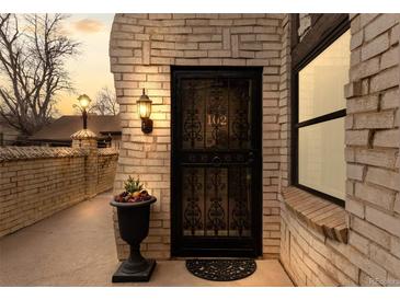 Charming home with an elegant wrought iron front door and well-lit entry, offering a warm welcome at 7201 E Quincy Ave # 102, Denver, CO 80237