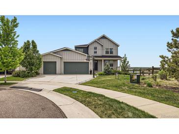 Charming two-story home with a well-maintained lawn and a three-car garage at 4526 Colorado River Dr, Firestone, CO 80504