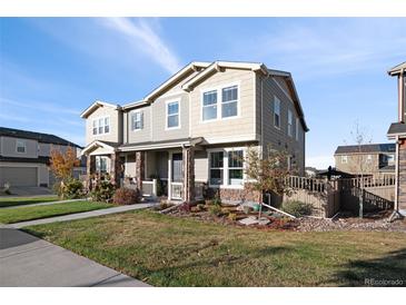 Charming two-story home with a covered porch, stone accents, and a well-maintained lawn at 3061 Low Meadow Blvd, Castle Rock, CO 80109
