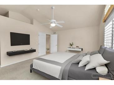Comfortable primary bedroom with a ceiling fan, neutral tones and an ensuite bathroom at 4042 E Hinsdale Cir, Centennial, CO 80122