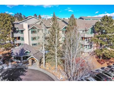 Attractive exterior of a multi-unit building with parking and landscaping at 31819 Rocky Village Dr # 216, Evergreen, CO 80439