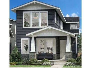 Charming two-story home with a covered porch and modern architectural details at 612 Apex St, Erie, CO 80516
