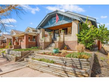 Charming brick home with a lovely landscaped front yard and an inviting front porch at 525 N Pearl St, Denver, CO 80203
