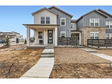 Charming two-story home features a welcoming porch, neutral color palette, and modern design at 2653 W 69Th Dr, Denver, CO 80221