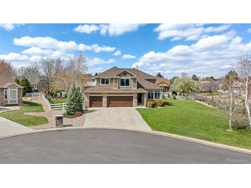 Beautiful two-story home with a three-car garage and well-maintained front yard at 14461 Inca Ct, Westminster, CO 80023