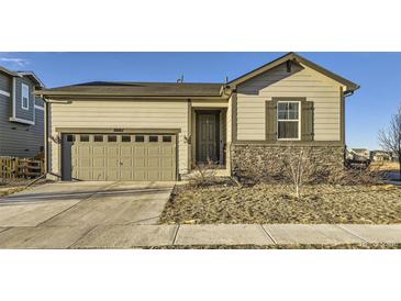 Charming single Gathering home featuring stone accents, a two car garage and neutral tones at 18187 E 99Th Ave, Commerce City, CO 80022