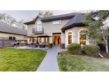 An entertainer's backyard features a patio, firepit, outdoor kitchen, and meticulous landscaping at 1160 Monaco Pkwy, Denver, CO 80220