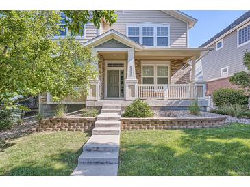 Charming front porch with brick accents, inviting entrance, and well-maintained landscaping at 9523 Gray Ct, Westminster, CO 80031