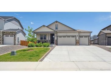 Charming single-Gathering home with a three-car garage, manicured lawn, and attractive stone and siding details at 14670 Guernsey Dr, Mead, CO 80542
